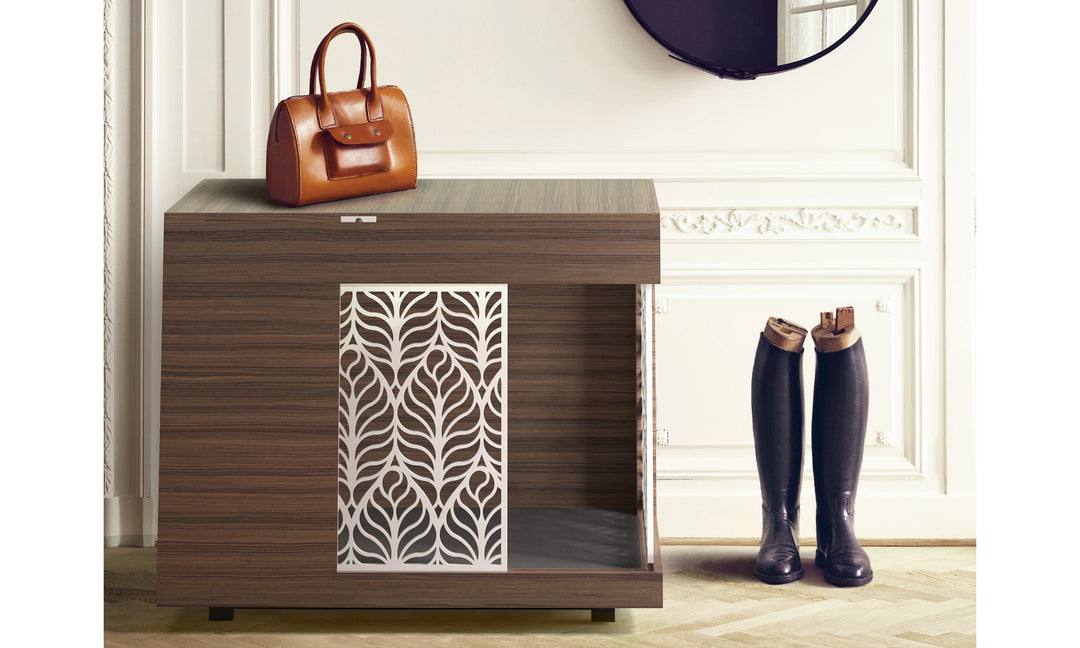 A modern, refined credenza in Italian-made Rosewood that is 33.5 in / 85 cm high stands against a classically elegant wall, possibly a foyer.  It has a front sliding door in a contemporary leaf design in chalk white for stunning contrast.  At the top are matching thumb trims to open hidden storage. On top is a fine leather handbag and riding boots are beside it on the right.