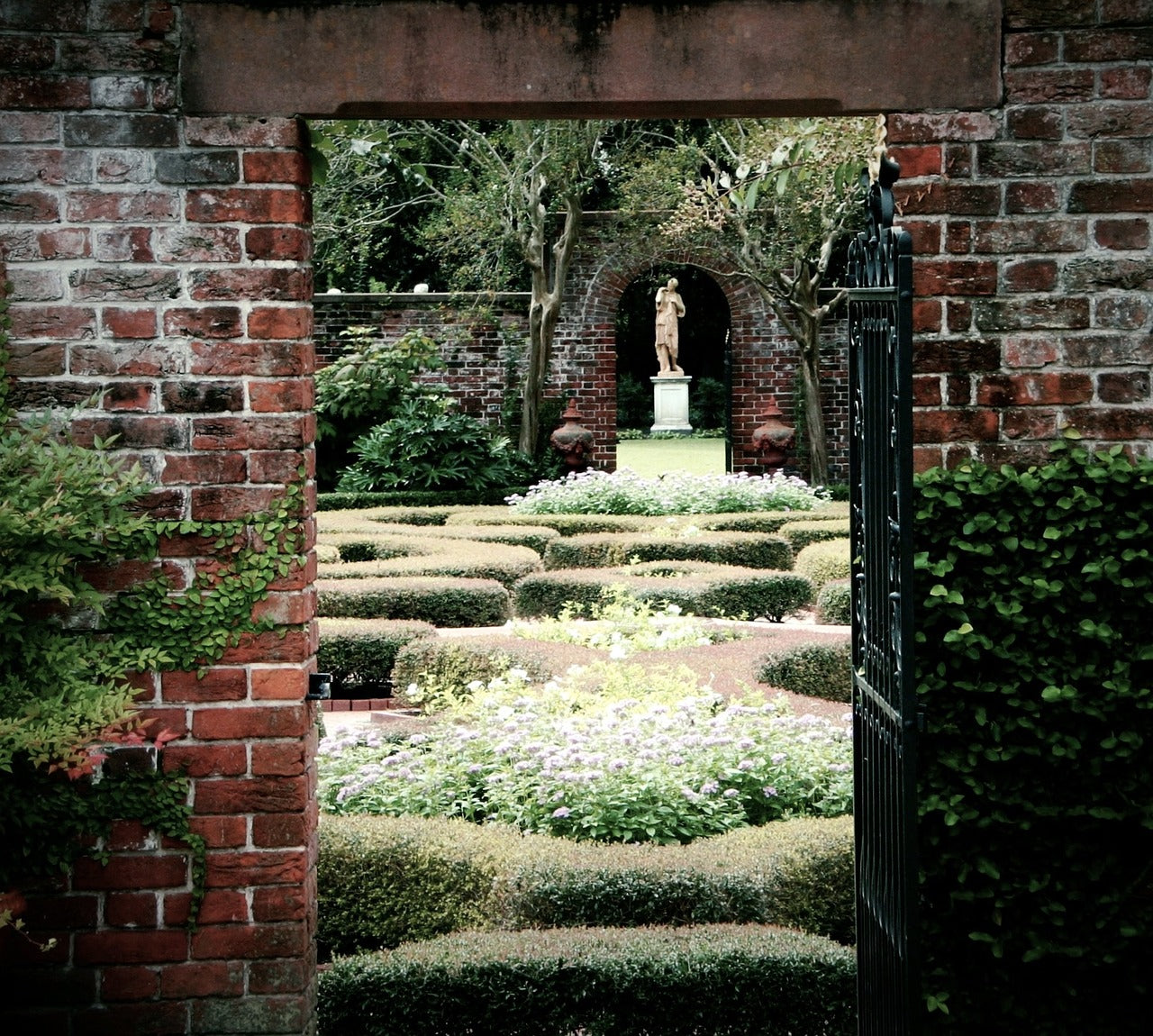 A beautiful sculpted garden view through an open doorway.